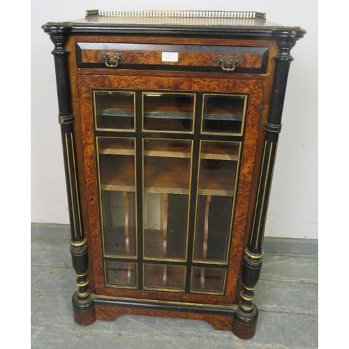 815 - A late Victorian burr walnut ebonised and inlaid music cabinet, having brass ¾ gallery above one lon... 