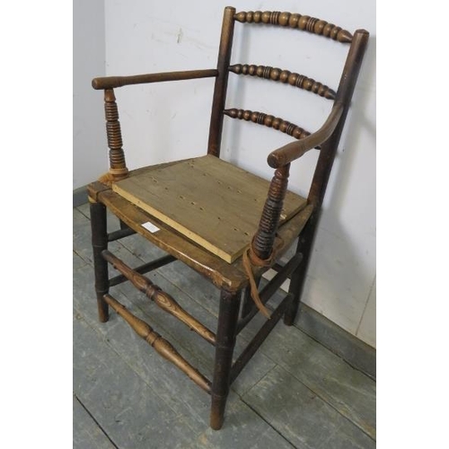 818 - A 19th century elm ‘Sussex’ chair, having ball turned back spindles, the back joined with curved arm... 