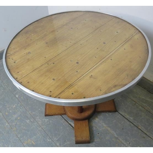 823 - An Art Deco Period light oak coffee table, the inset glass top with aluminium banding, on a cluster ... 