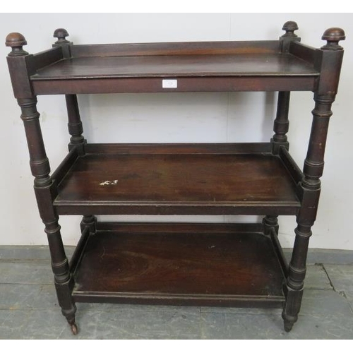 829 - A Victorian mahogany three-tier buffet, having domed finials and turned uprights, on tapered support... 