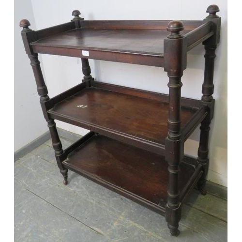 829 - A Victorian mahogany three-tier buffet, having domed finials and turned uprights, on tapered support... 