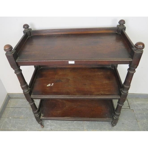 829 - A Victorian mahogany three-tier buffet, having domed finials and turned uprights, on tapered support... 