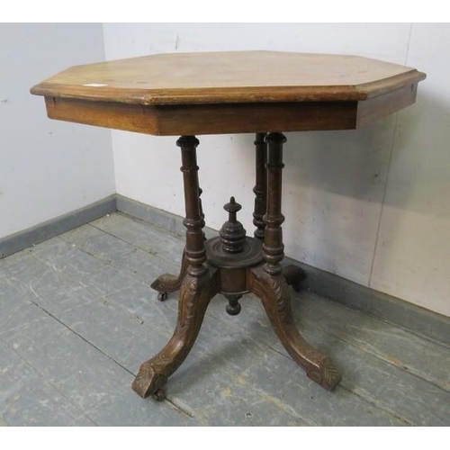 832 - A Victorian walnut octagonal centre table, the quarter veneered top with marquetry inlay, on a clust... 