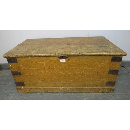 833 - An antique pine flat topped trunk/blanket box, having metal strapwork and cast iron 
handles to eith... 