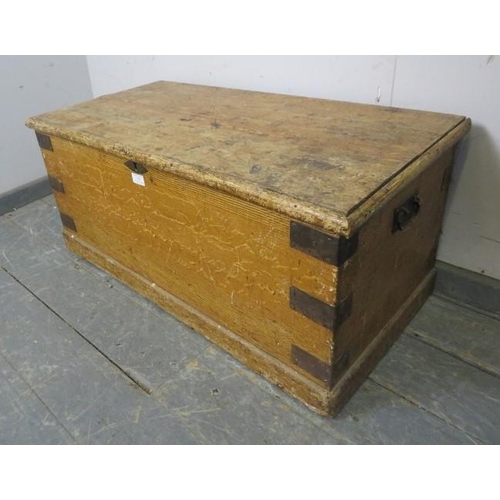 833 - An antique pine flat topped trunk/blanket box, having metal strapwork and cast iron 
handles to eith... 