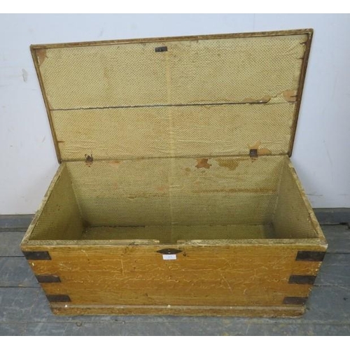 833 - An antique pine flat topped trunk/blanket box, having metal strapwork and cast iron 
handles to eith... 