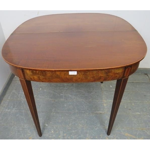 834 - A Georgian mahogany turnover tea table, crossbanded and strung with boxwood, satinwood and ebony, on... 