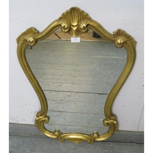 838 - A vintage giltwood wall mirror in the early Georgian taste, within a shaped surround decorated with ... 