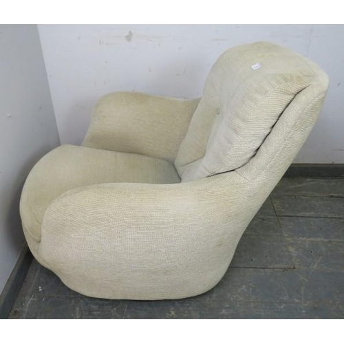 844 - A vintage mid-century ‘space age’ armchair, reupholstered in neutral buttoned material, on a swivel ... 