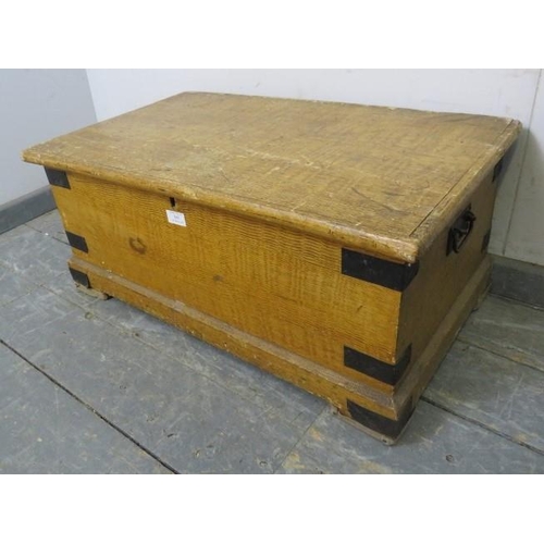 845 - An antique pine flat topped trunk/blanket box, having metal strapwork mounts and carry handles to ei... 