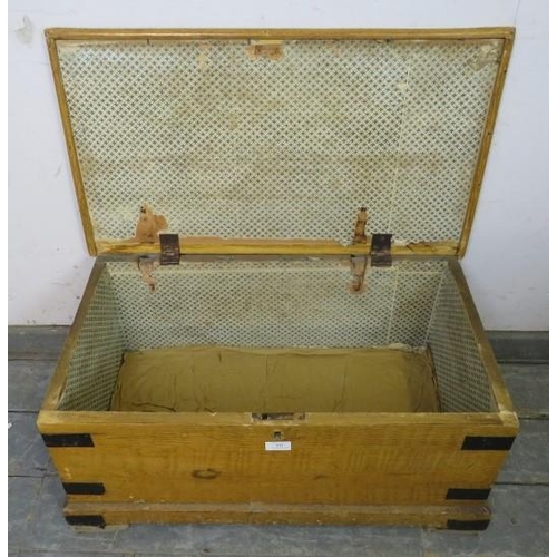 845 - An antique pine flat topped trunk/blanket box, having metal strapwork mounts and carry handles to ei... 