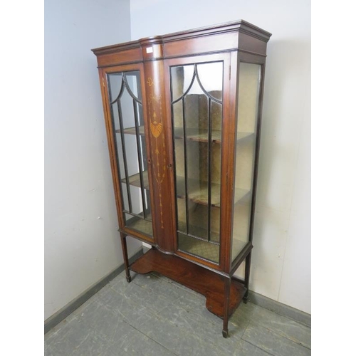 847 - An Edwardian mahogany glazed display cabinet strung with satinwood, having bow-fronted marquetry inl... 