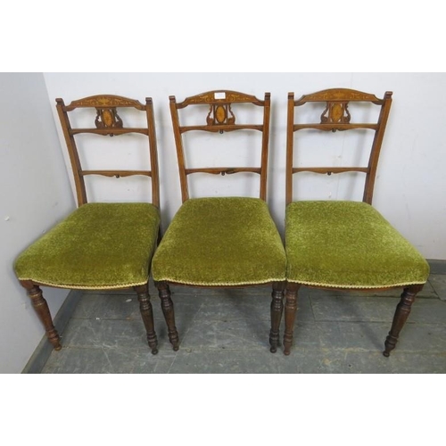 853 - A trio of Edwardian rosewood occasional chairs, the pierced backs with marquetry inlay, on turned su... 