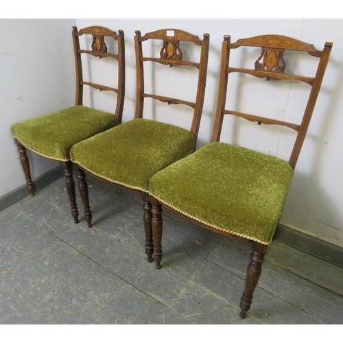 853 - A trio of Edwardian rosewood occasional chairs, the pierced backs with marquetry inlay, on turned su... 