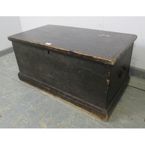 857 - A 19th century ebonised flat-topped trunk/blanket box with cast iron handles to either side, on a pl... 