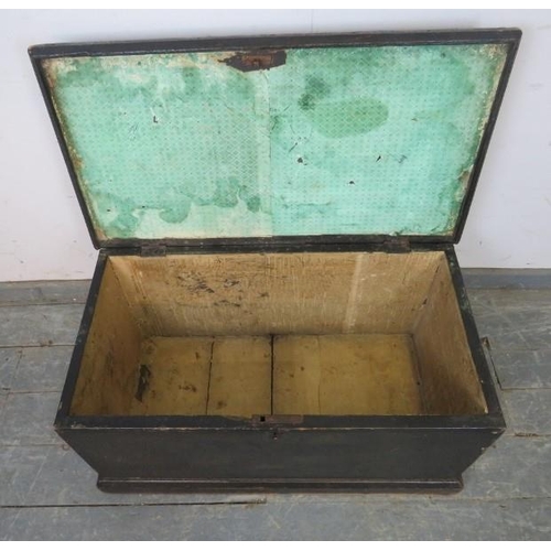 857 - A 19th century ebonised flat-topped trunk/blanket box with cast iron handles to either side, on a pl... 