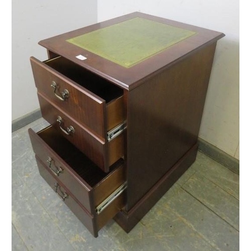 858 - A reproduction mahogany filing cabinet, the top with inset green leather, housing two deep drawers w... 