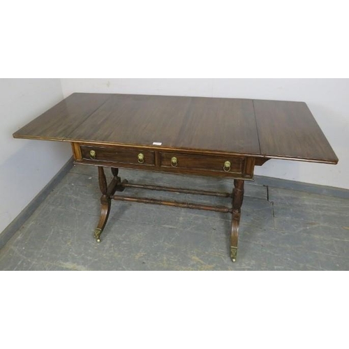 859 - A vintage mahogany sofa table in the Regency taste, having short cock-beaded drawers with gilt brass... 