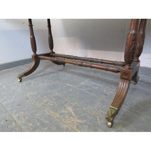 859 - A vintage mahogany sofa table in the Regency taste, having short cock-beaded drawers with gilt brass... 