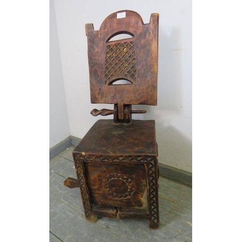 860 - Tribal Art: An African carved wood chair, Cameroon. Modelled with a detachable backrest, storage com... 