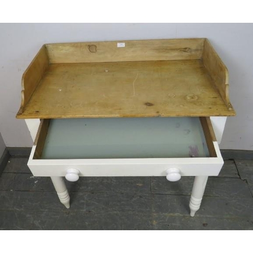 869 - An antique pine washstand, having ¾ gallery, the single frieze drawer fitted with ceramic knob handl... 