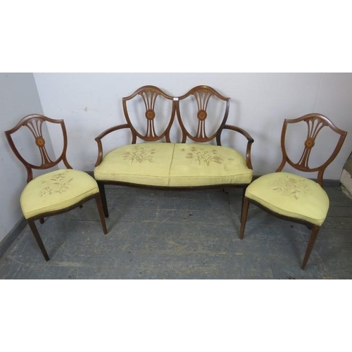 872 - An Edwardian mahogany three-piece suite comprising an open sided sofa and two chairs, the pierced sh... 