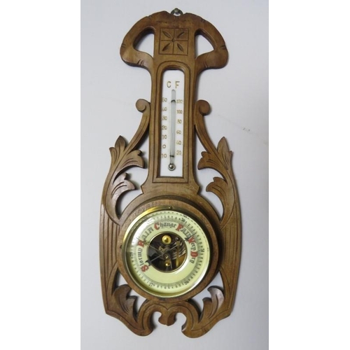 873 - A late Victorian walnut aneroid barometer/thermometer of small proportions within an acanthus carved... 