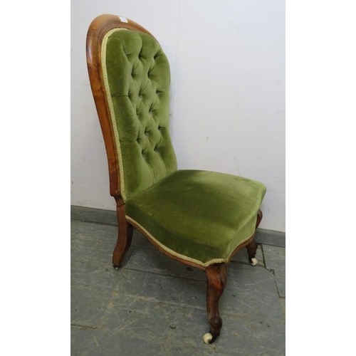 875 - A Victorian walnut show-wood bedroom chair, upholstered in buttoned green velvet material, on ogee s... 