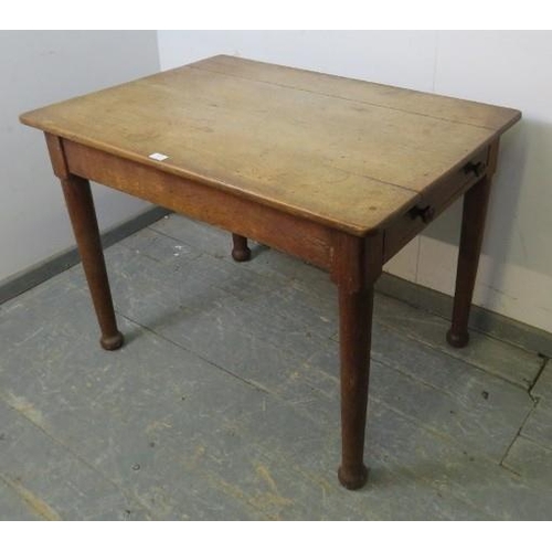 876 - A turn of the Century light oak farmhouse kitchen table, having one long drawer to either side with ... 