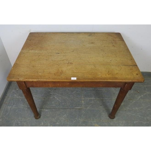 876 - A turn of the Century light oak farmhouse kitchen table, having one long drawer to either side with ... 