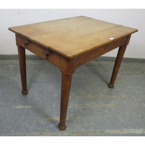 876 - A turn of the Century light oak farmhouse kitchen table, having one long drawer to either side with ... 