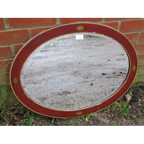 882 - A 19th Century oval bevelled wall mirror, within a faux mahogany gesso surround with hand painted ba... 