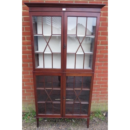 883 - An Edwardian mahogany tall, glazed display cabinet of unusually narrow proportions, the four astral ... 