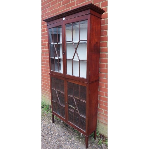 883 - An Edwardian mahogany tall, glazed display cabinet of unusually narrow proportions, the four astral ... 