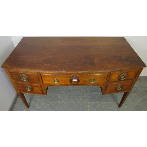 894 - An antique mahogany bow-fronted kneehole writing desk, having a configuration of five drawers with b... 