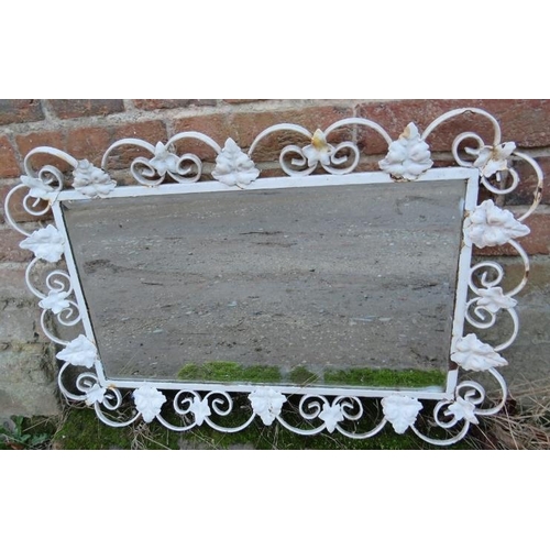 897 - A vintage outdoor bevelled wall mirror within a scrolled wrought iron frame painted white, having ap... 