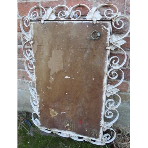 897 - A vintage outdoor bevelled wall mirror within a scrolled wrought iron frame painted white, having ap... 