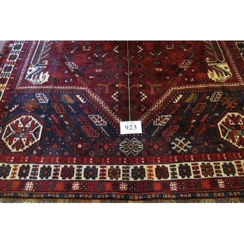 923 - A fine South West Persian Qashqai carpet central blue motif on a deep red ground. Good quality, deep... 