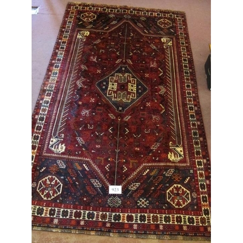 923 - A fine South West Persian Qashqai carpet central blue motif on a deep red ground. Good quality, deep... 