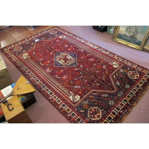 923 - A fine South West Persian Qashqai carpet central blue motif on a deep red ground. Good quality, deep... 