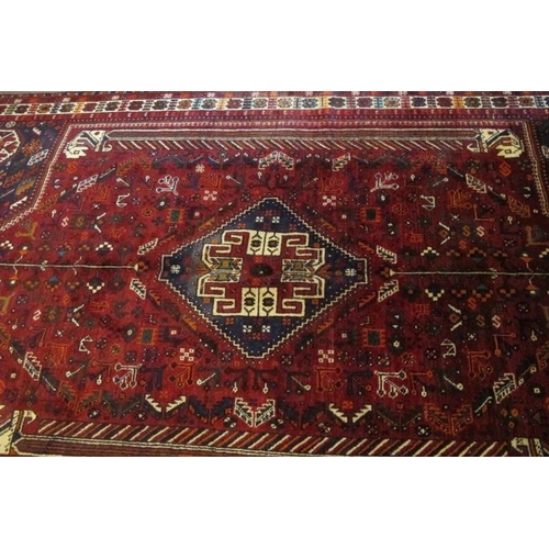 923 - A fine South West Persian Qashqai carpet central blue motif on a deep red ground. Good quality, deep... 