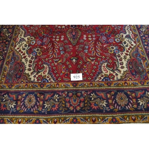 925 - North west Tabriz carpet, central motif on a deep red ground and wide blue border. 305cm x 200cm (ap... 