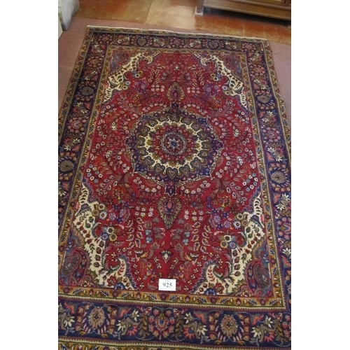 925 - North west Tabriz carpet, central motif on a deep red ground and wide blue border. 305cm x 200cm (ap... 