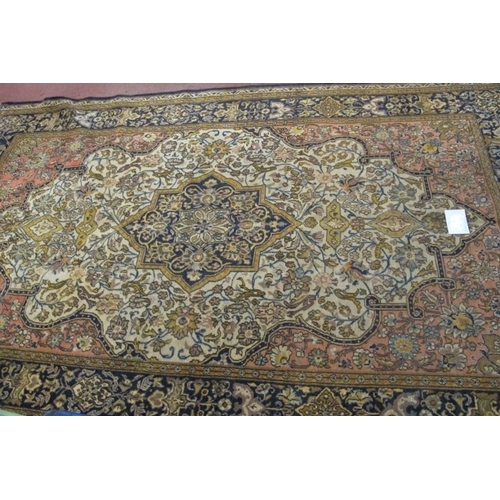 926 - A central Persian Isfahan carpet central floral motif cream, red, blue, with wide borders. In good c... 