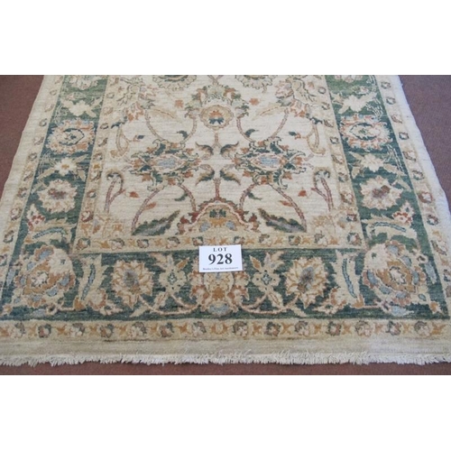 928 - A late 20th century wool rug. Flower design, green on cream ground, nice rug. Good clean condition. ... 