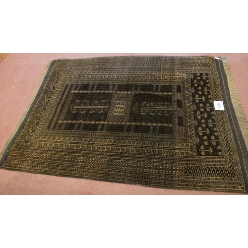 930 - A 20th century Turkoman rug. Central pattern on brown ground and intricate repeat border. 186cm x 13... 