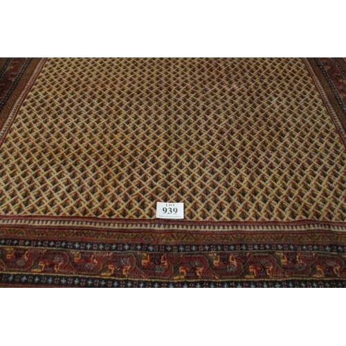 939 - Central Persian Arak carpet. A central repeat pattern arrangement on a cream ground. 310cm x 230cm (... 