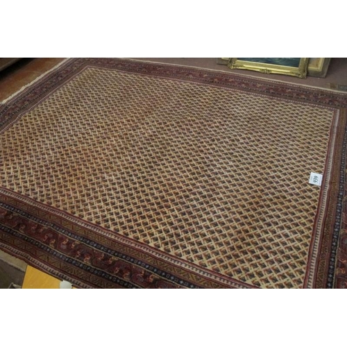 939 - Central Persian Arak carpet. A central repeat pattern arrangement on a cream ground. 310cm x 230cm (... 