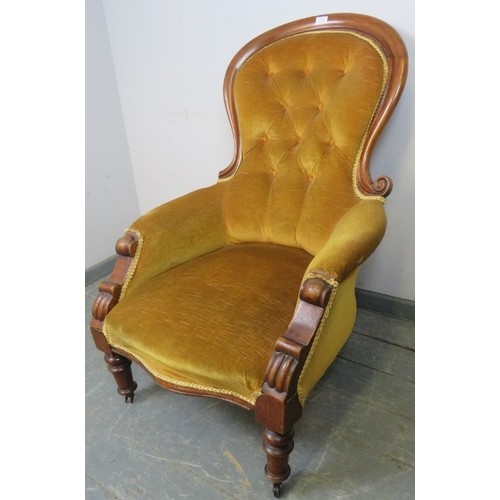 865 - A Victorian mahogany spoonback chair, upholstered in gold buttoned material with braid trim, on tape... 