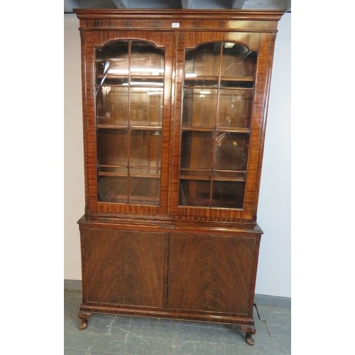 870 - An antique flame mahogany tall glazed bookcase, the tracery doors opening onto three height adjustab... 